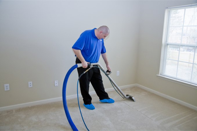 Carpet Cleaning Service tech cleaning a bedroom